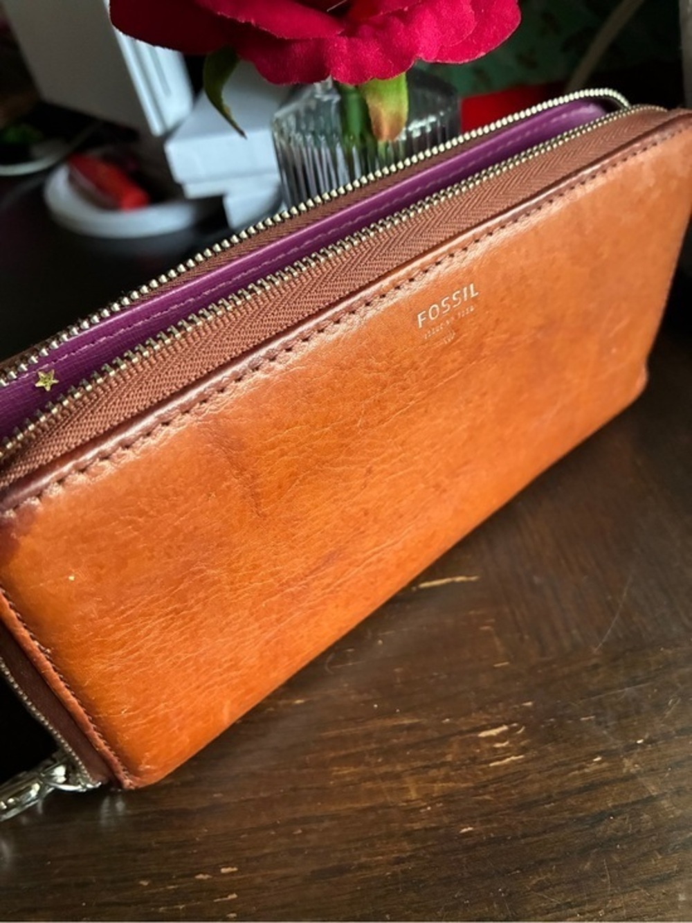 Fossil tan leather zip wallet with purple interior trim